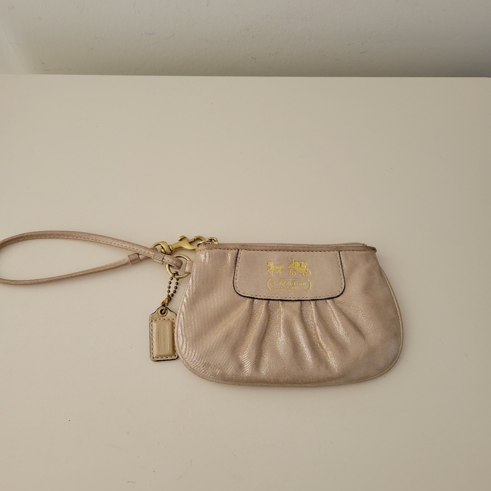 Coach champagne colored wristlet.